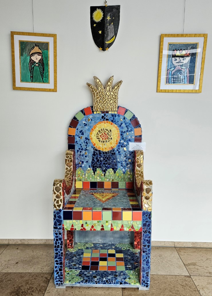 Thron mit Mosaik-Verzierung und gemalte Bilder von Königspaar im Hintergrund